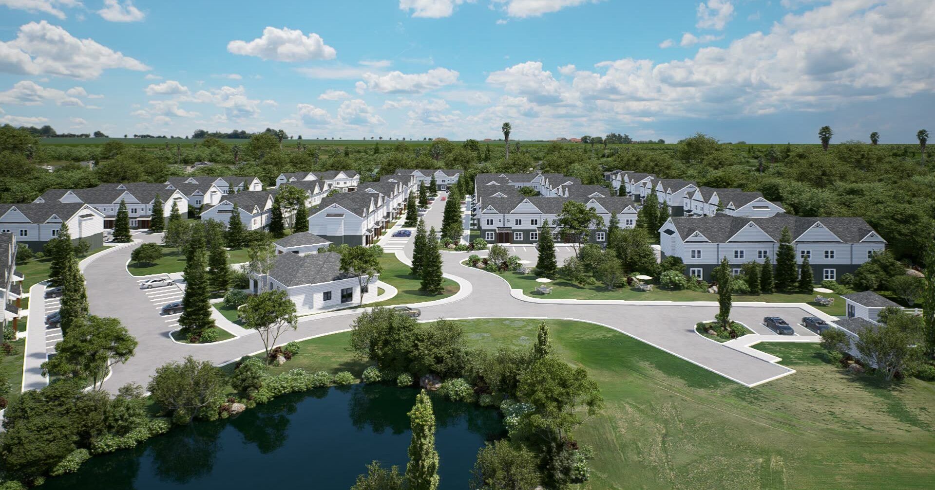 Townhomes in Weaverville, NC, with In-Unit Washer and Dryer - Encore at Reems Creek - An Elevated View of the Community Featuring Numerous Brand-New Townhomes with Dark Roofs, Surrounded by Landscaping and Roads, Overlooking a Lush Green Wooded Setting.